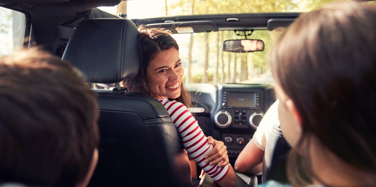 woman in the car with kids