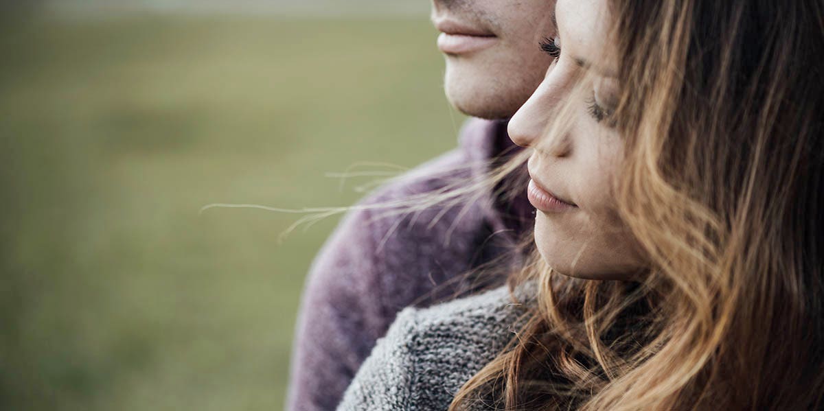 What It's Really Like To Be In A Codependent Marriage couple gazing together background of grass