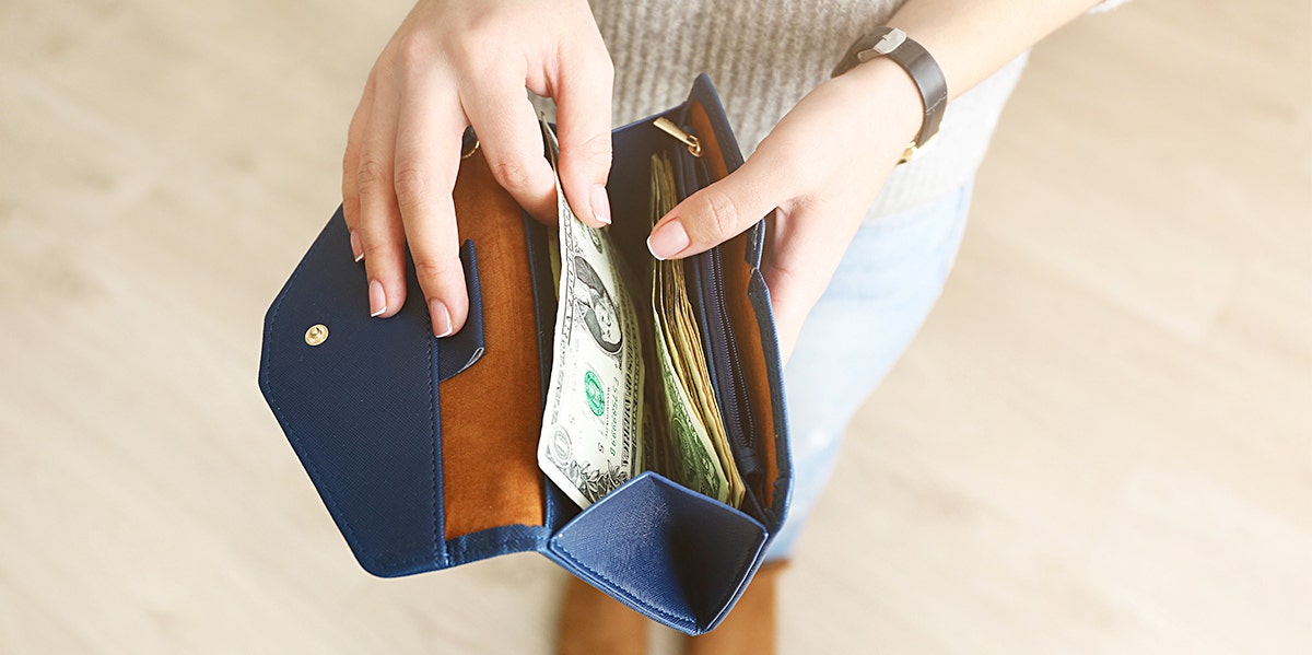 photo of woman opening wallet