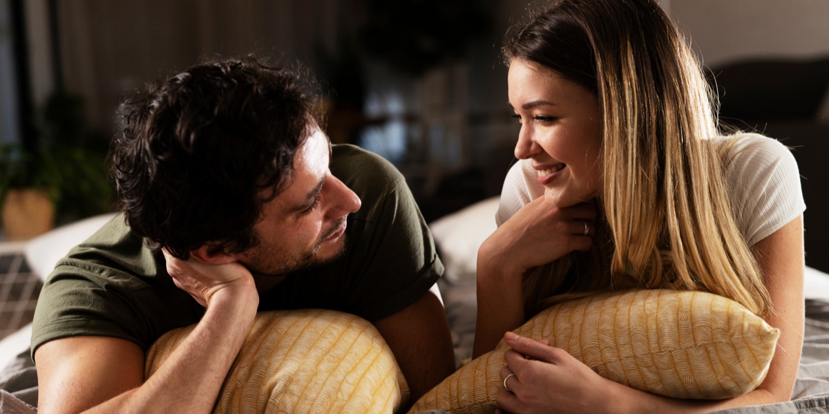 couple lying in bed talking