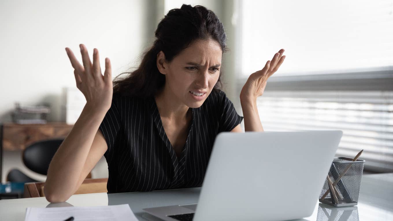 Company Offers Woman Full-Time Job Without Vacation Time For The First 2 Years upset woman looking a job offer on computer