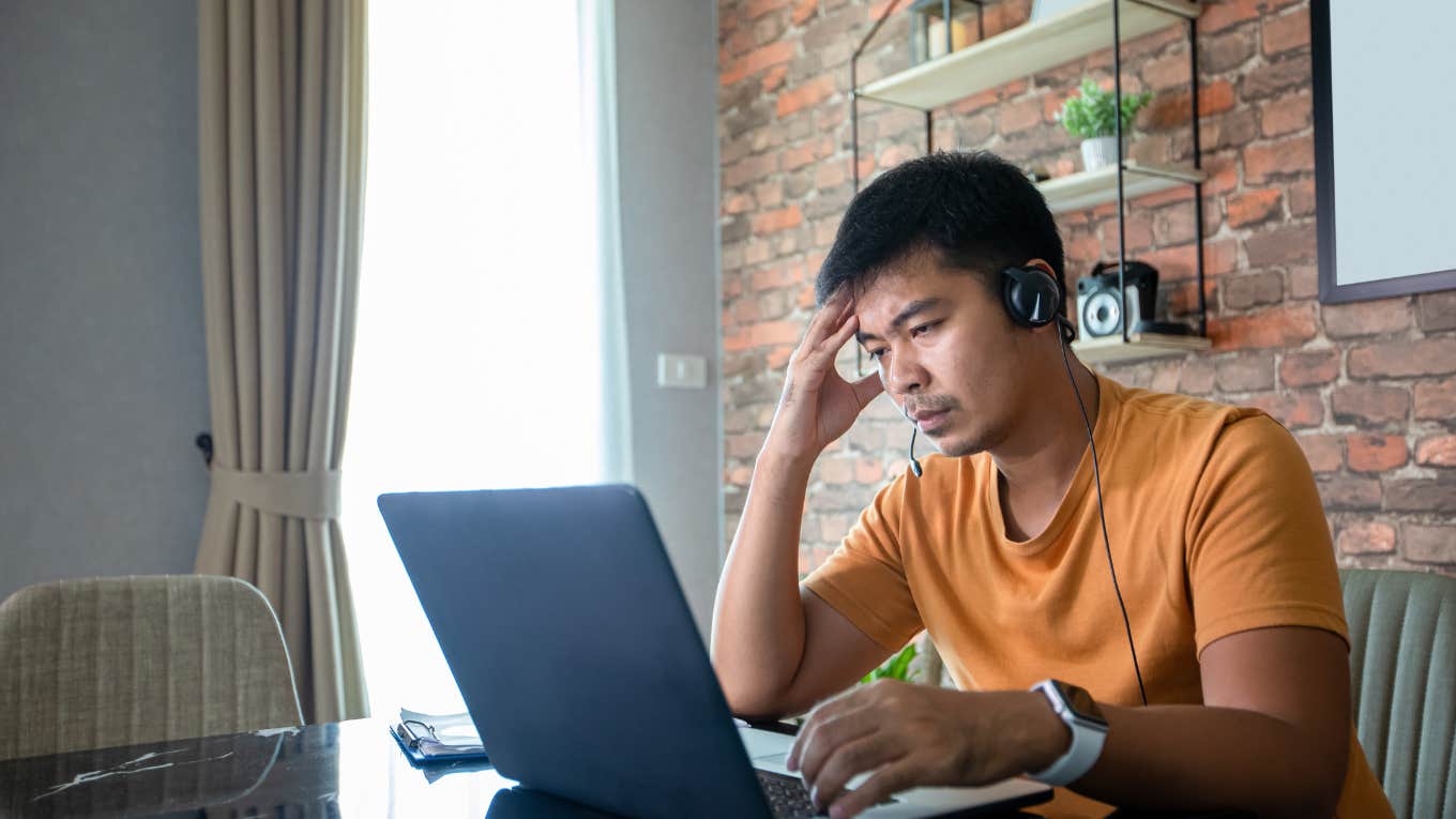 Upset man looking at laptop