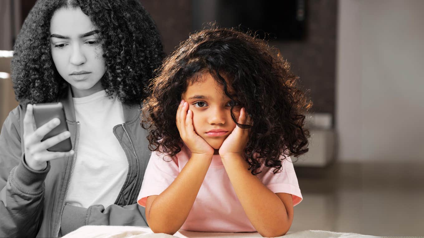 sad young girl in front of teen scrolling phone