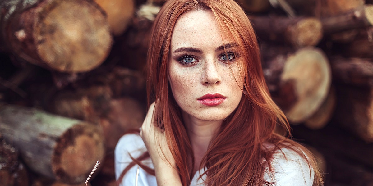 woman with red hair looking stern 