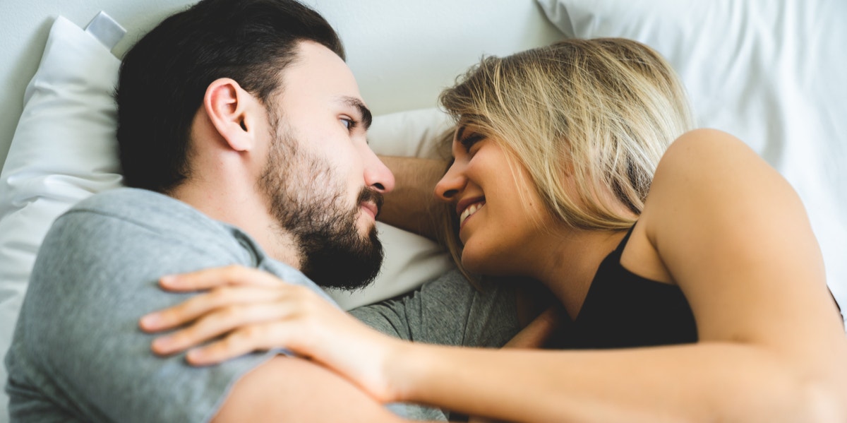 7 Components Of Intimacy Couples In The Best Relationships Have man and woman in bed talking