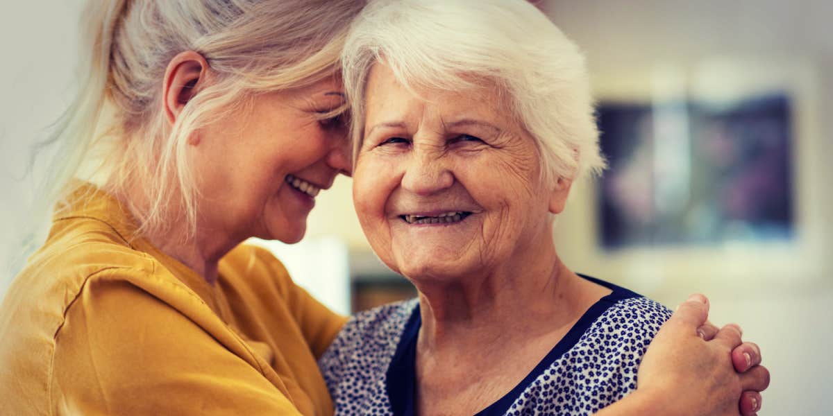 woman hugging an elderly female 