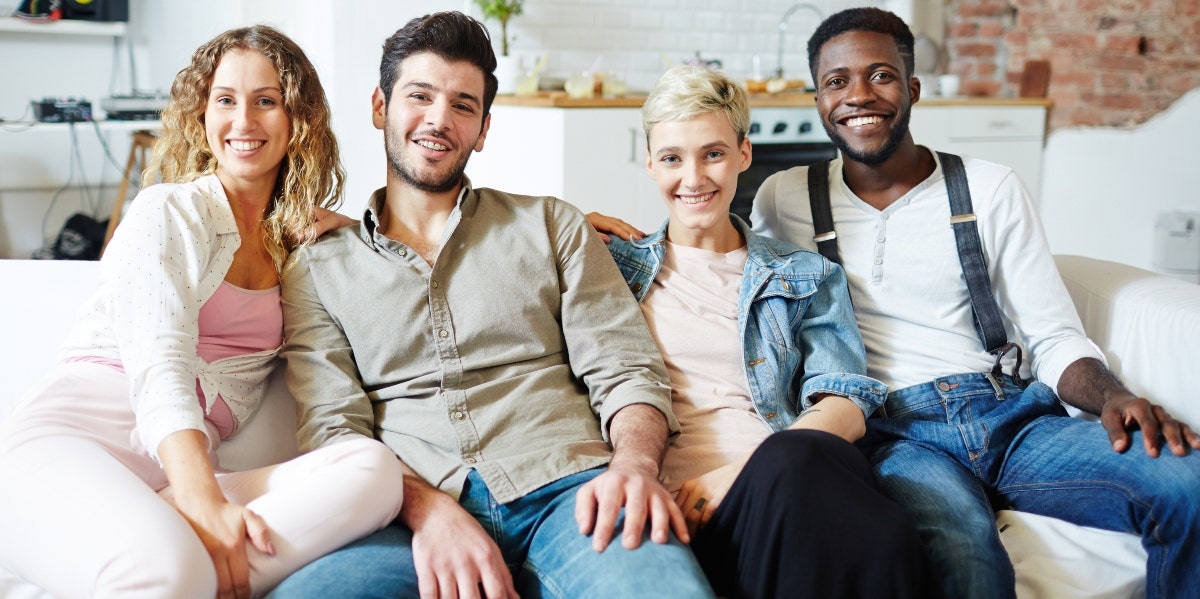 two men and two women sitting on couch