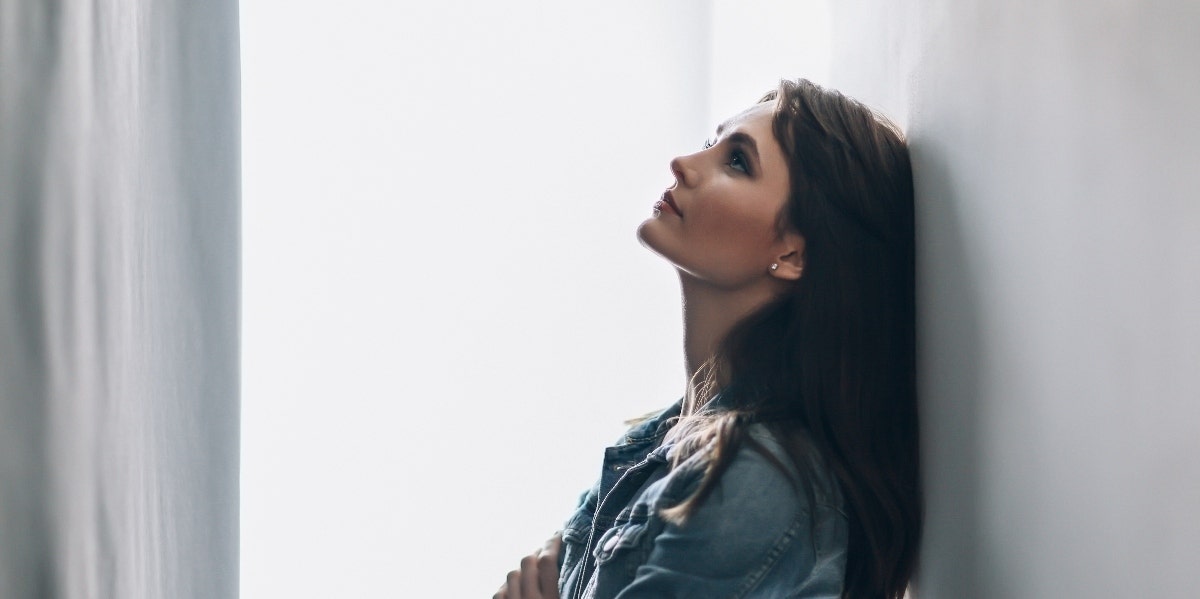 angry woman leaning head against the wall