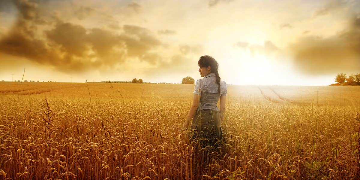 The Reality Of Being A Country Girl Living In The Big City woman in a field of wheat