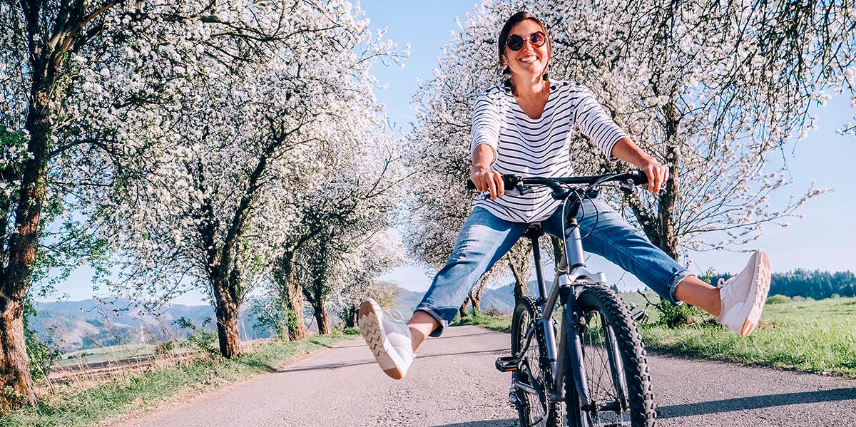woman happily riding bike