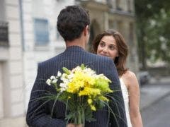 couple meeting for date outside surprise with flowers