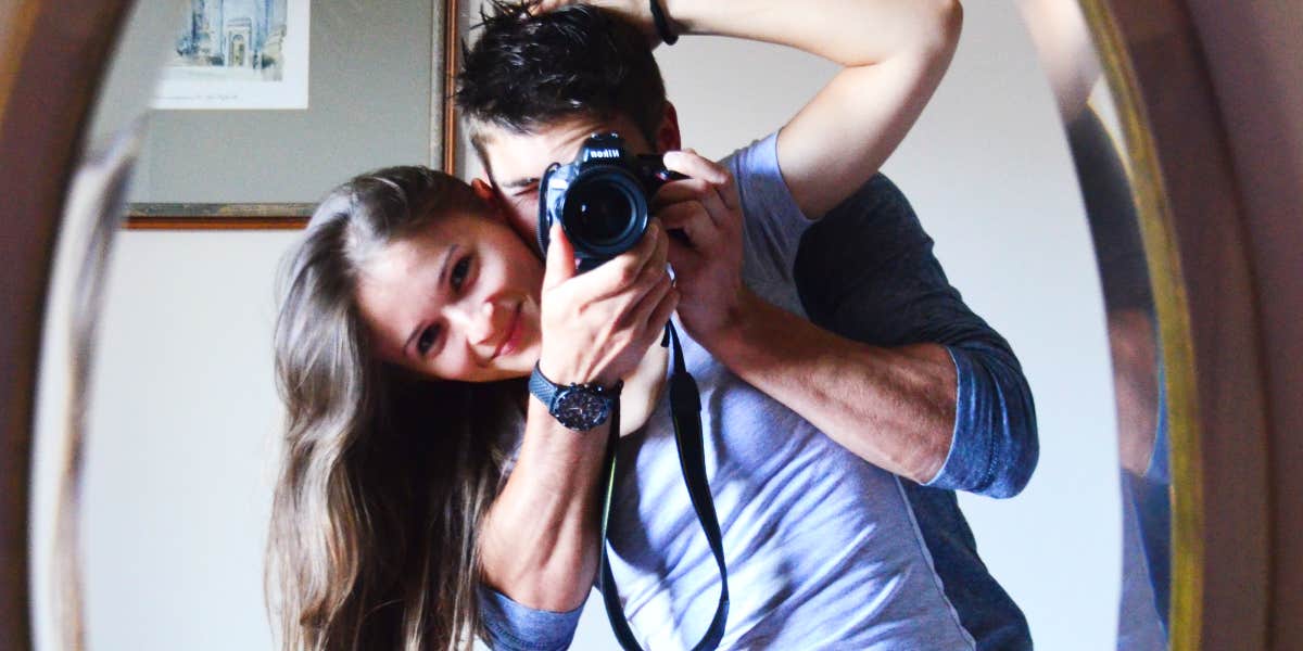 Couple taking a photo in the mirror