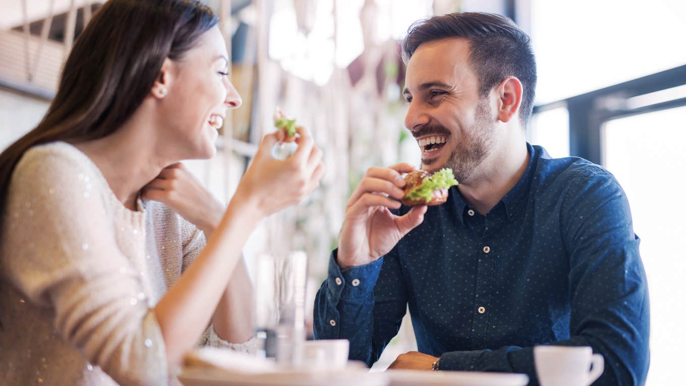 happy couple eating out at restaurant