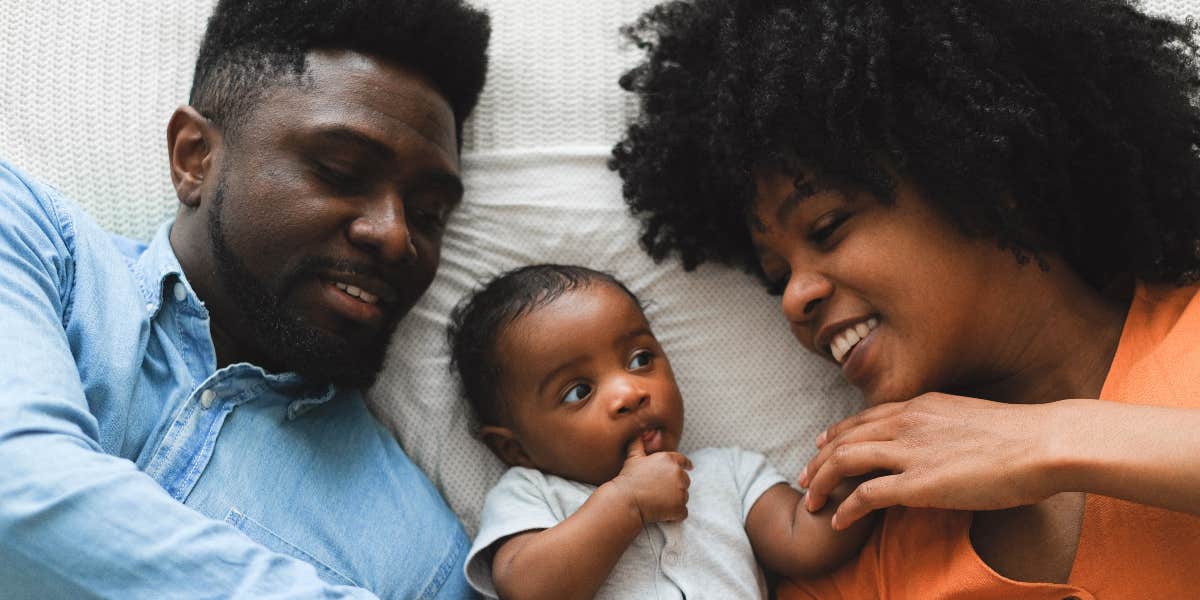 Couple lying down with baby