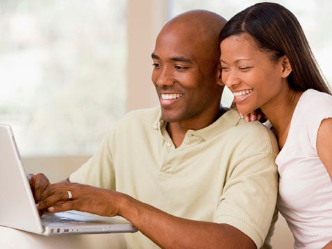happy couple sharing computer