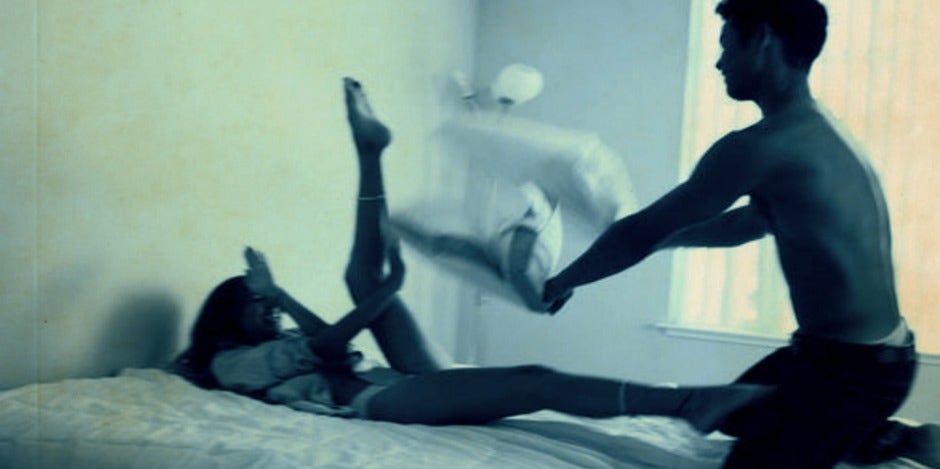 couple having a pillow fight couple having a pillow fight