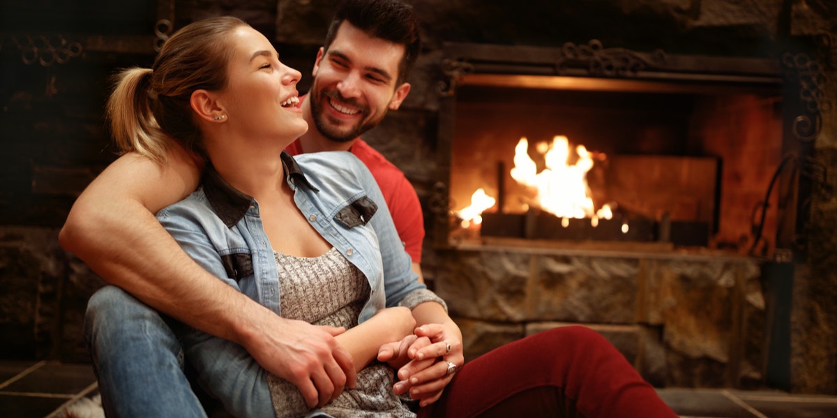 couple in front of fireplace