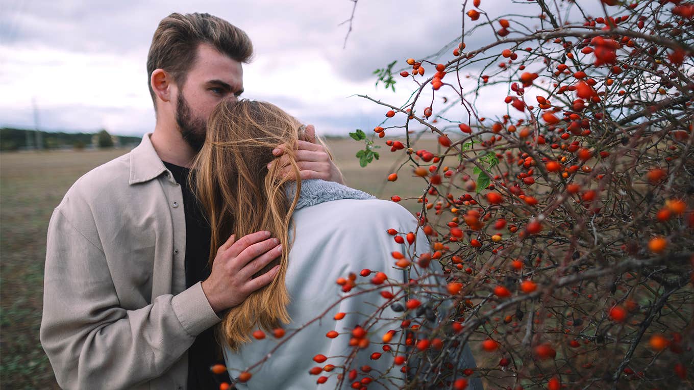 man kissing woman