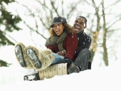 couple sledding in snow