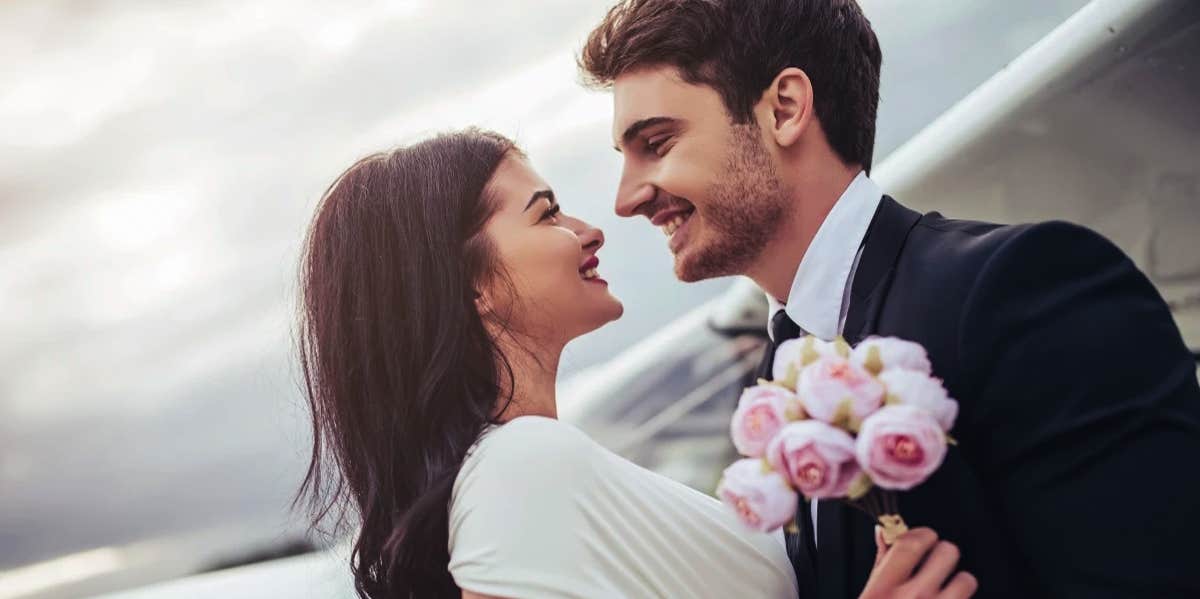 bride and groom smiling at each other