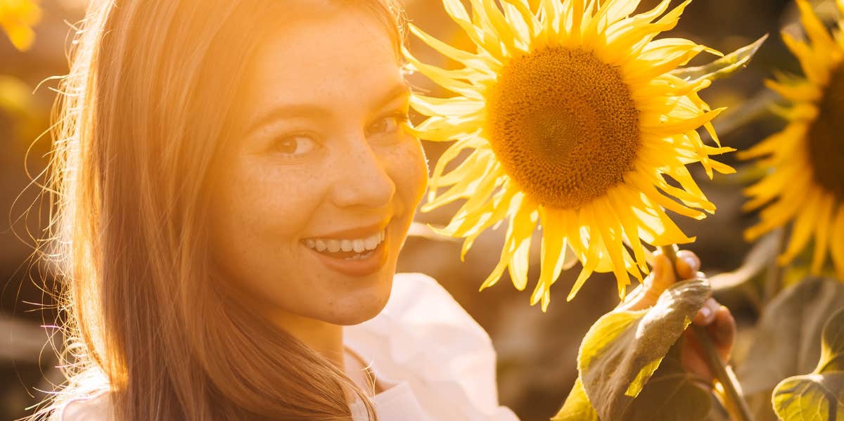 sunflower field and woman smiling