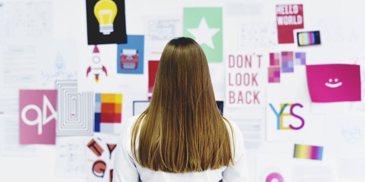 woman looking at vision board wall