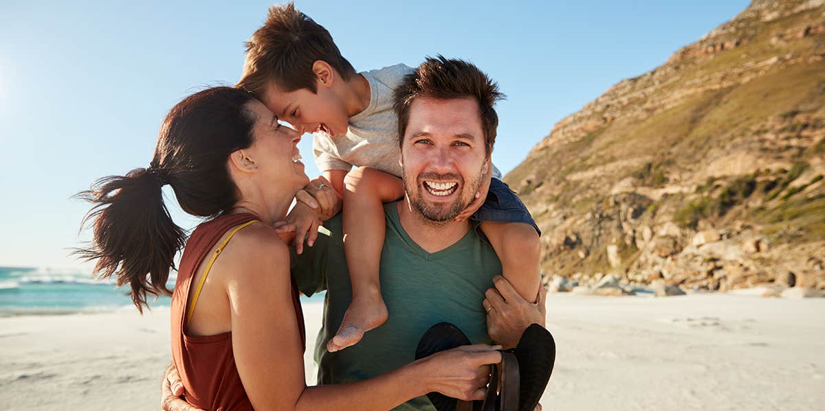 family on beach posing for photo