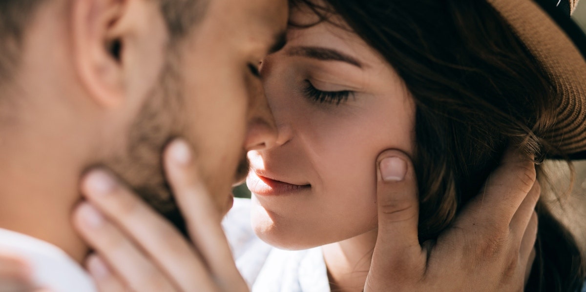 man and woman kissing