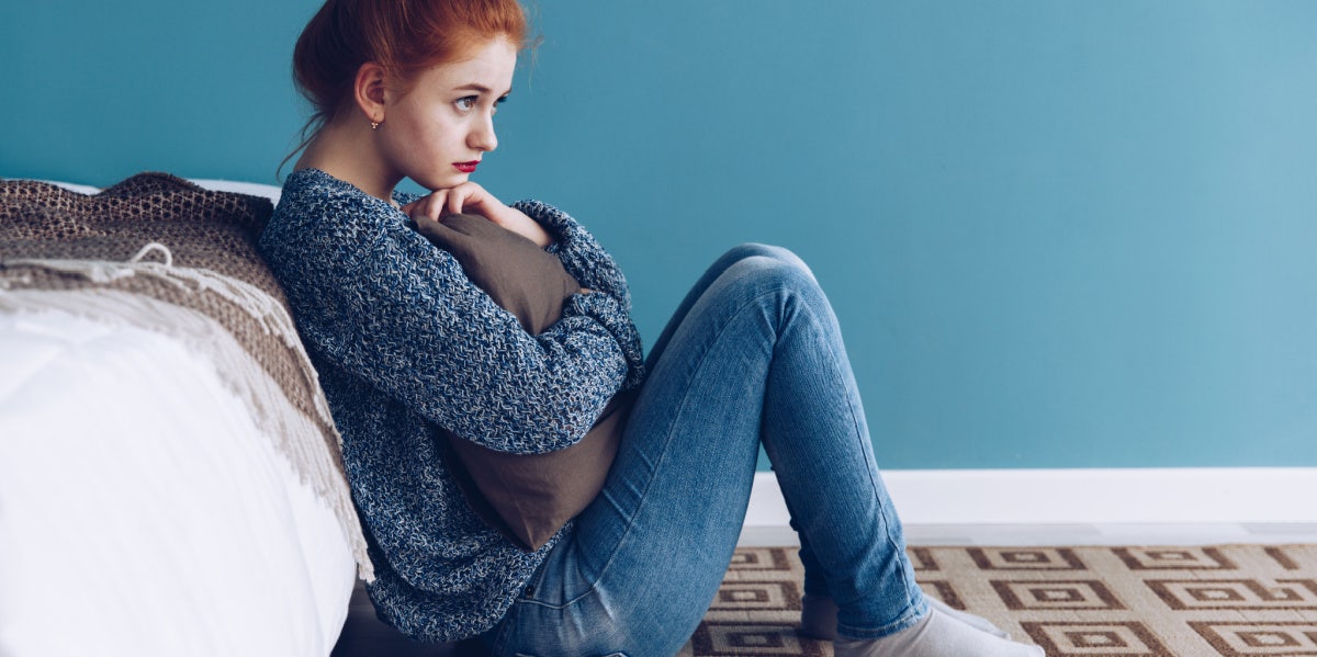 woman sitting bored on the floor