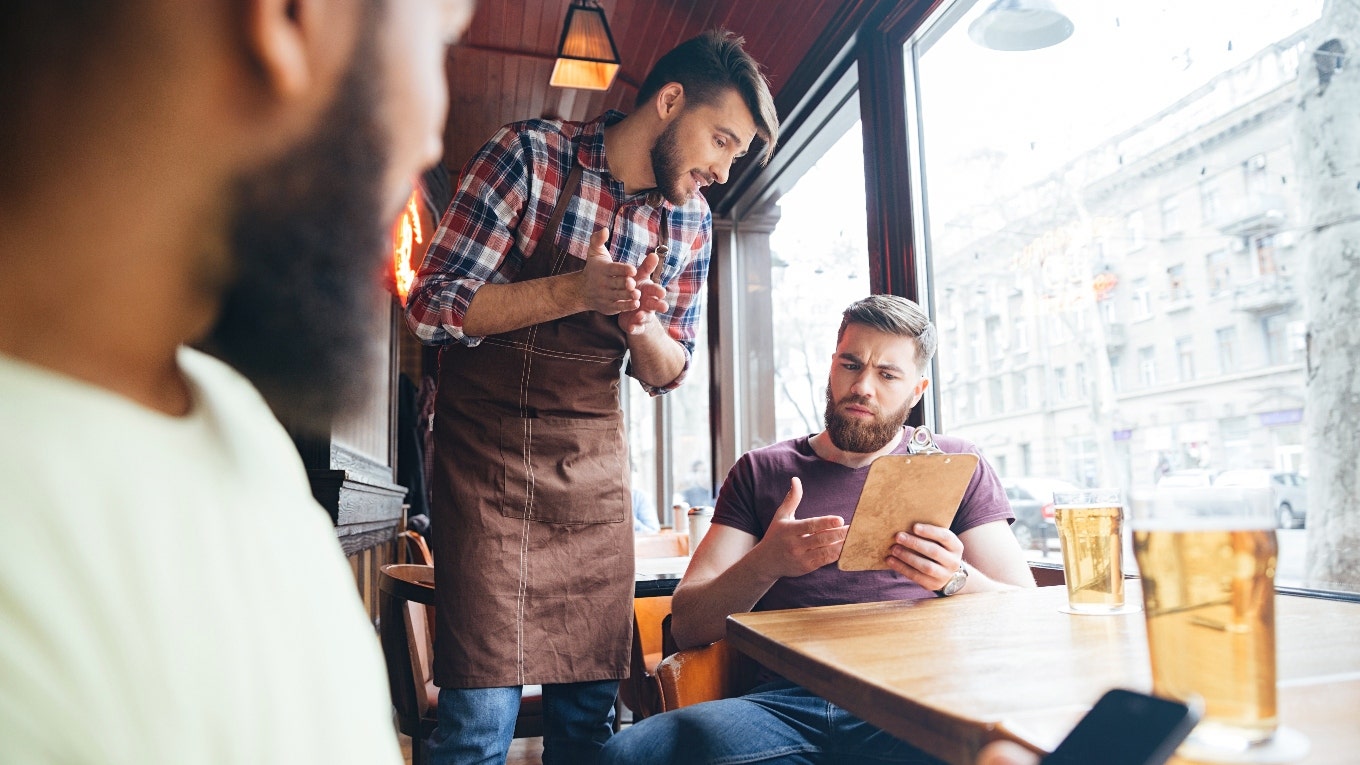 Customer Baffled After They Were Charged An Extra $15 For Having A Bad Attitude A waiter and a customer are arguing.