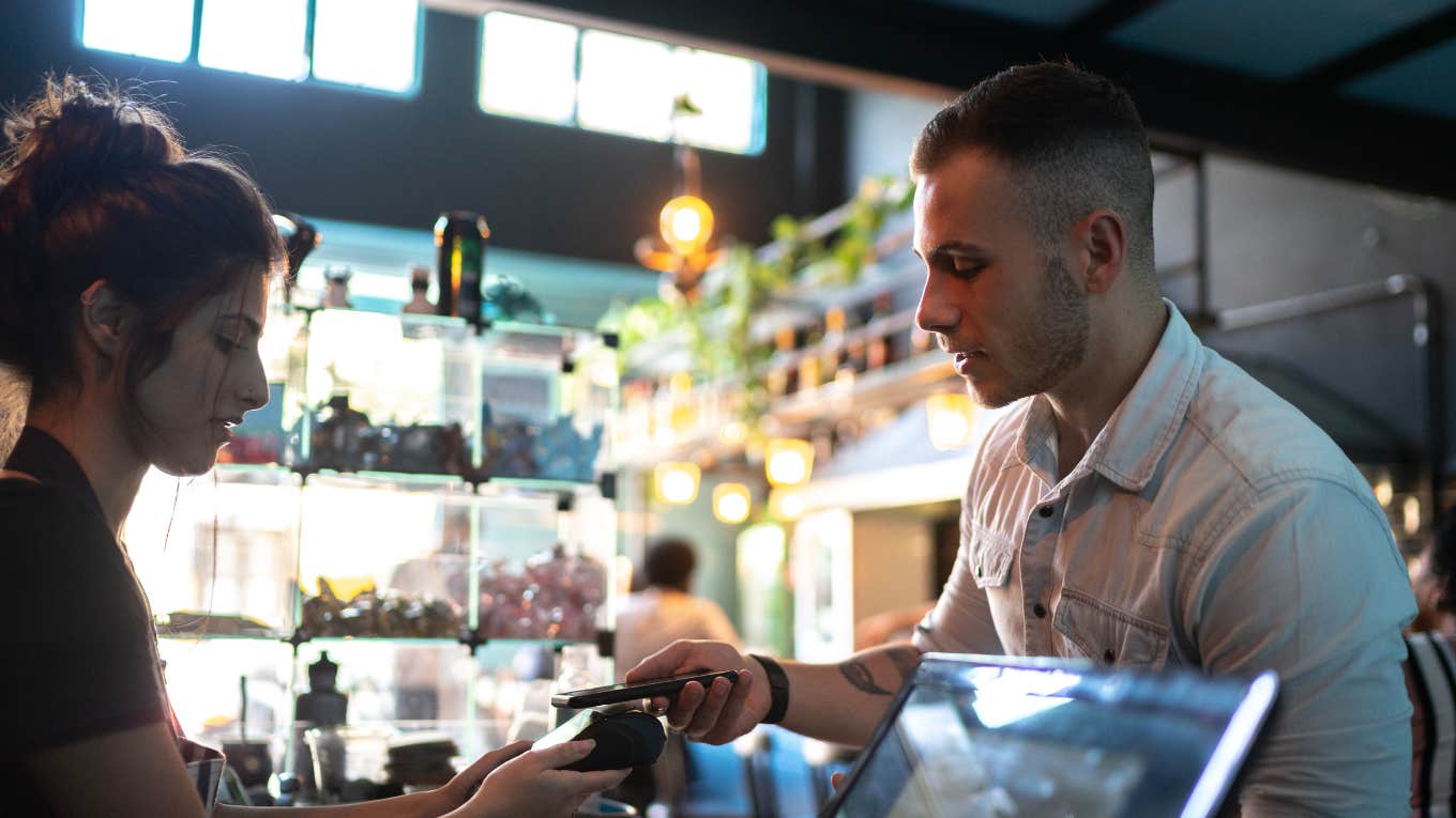 Customer paying bill contactless payment at restaurant