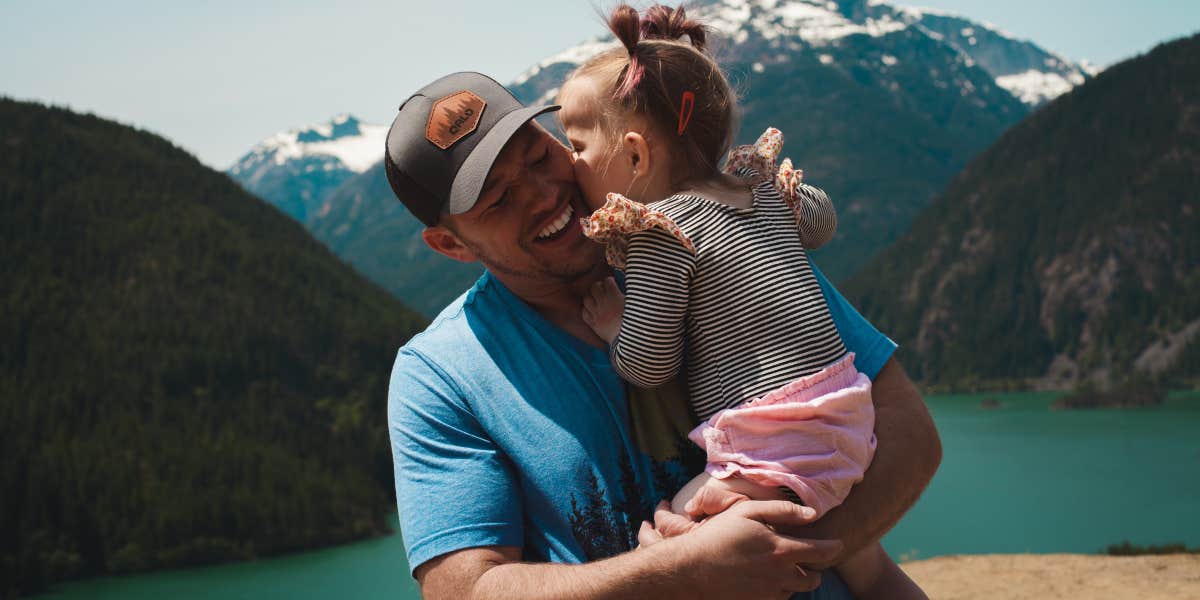 Dad and daughter hugging while on a hike