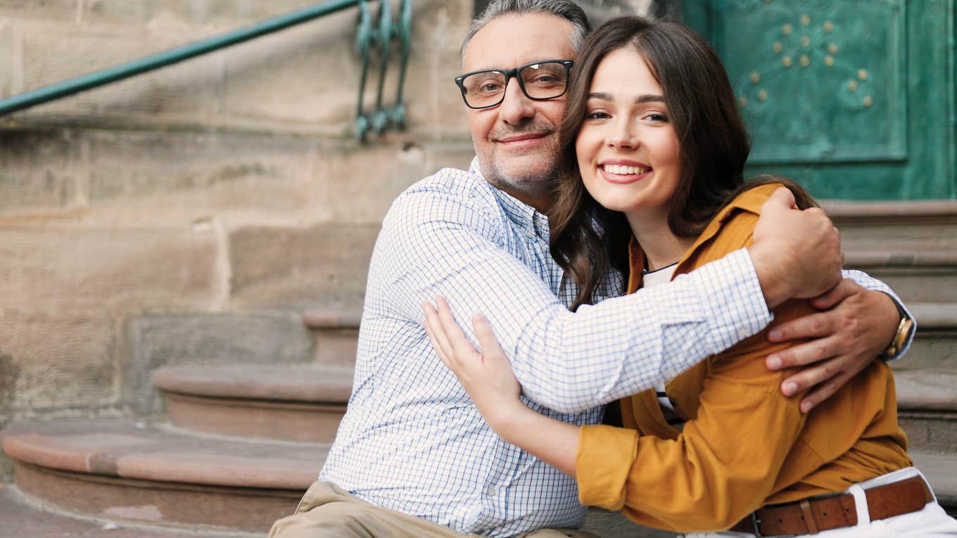 smiling father hugging daughter