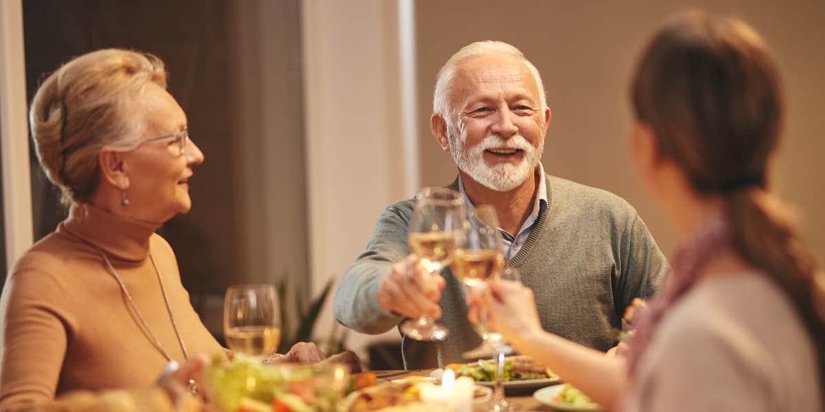 Father and daughter-in-law touching glasses