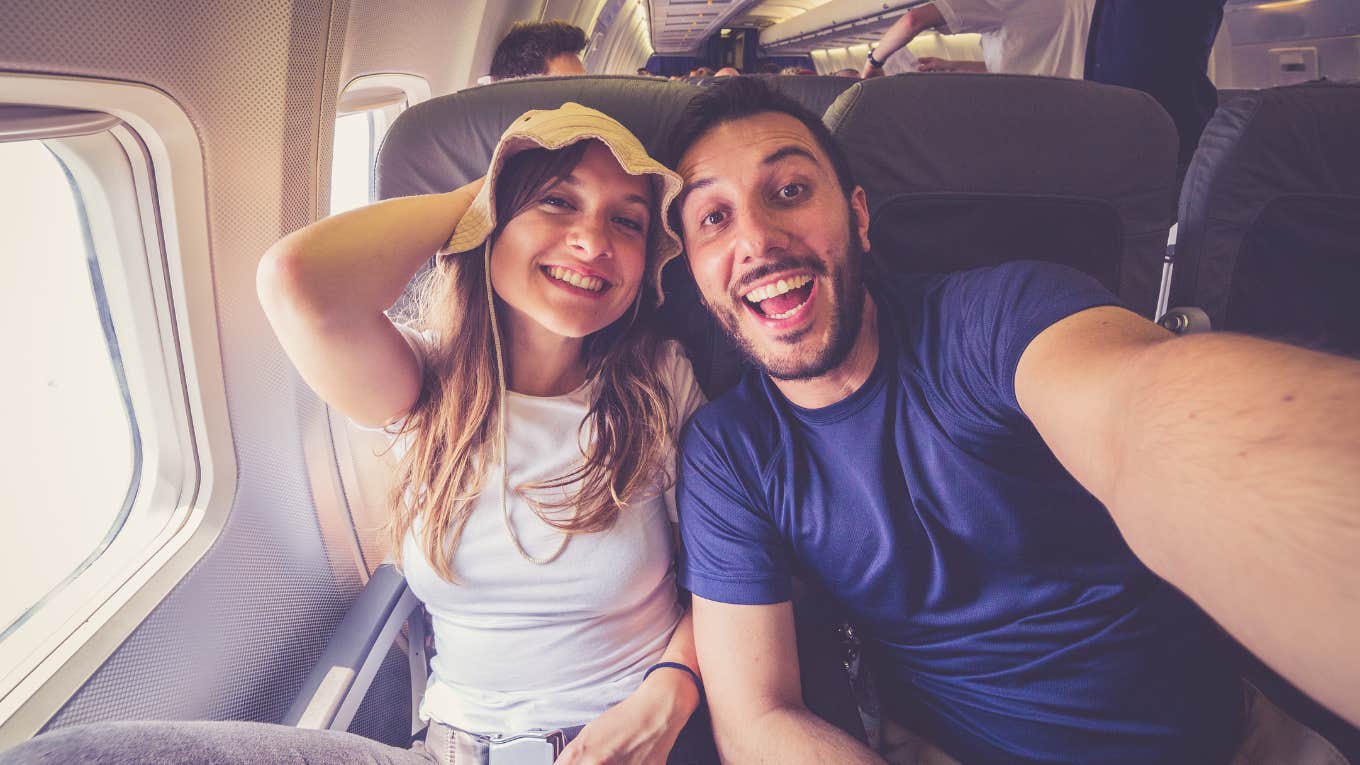 Dad Was Kicked Off A Flight For Taking A Photo On The Tarmac While He Was Boarding couple taking a selfie on the airplane during flight