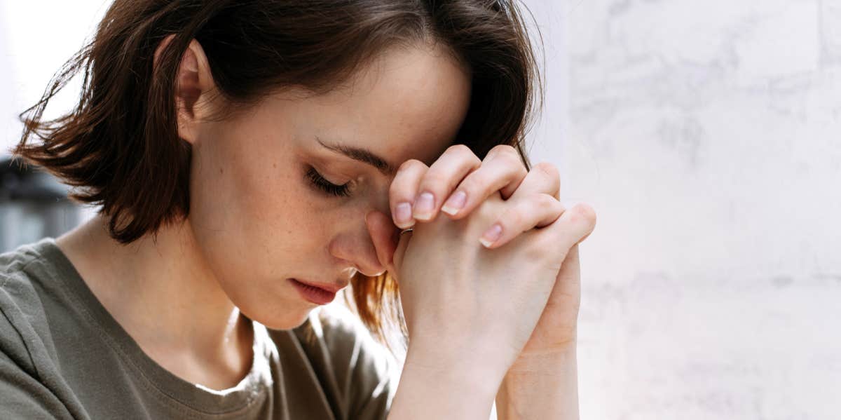 woman with hands on forehead