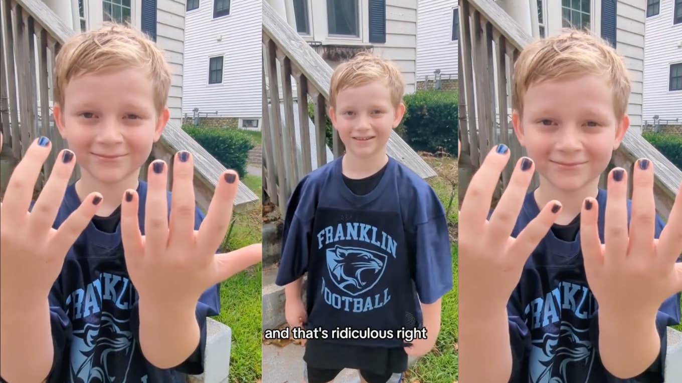 young boy wearing a football jersey and nail polish 