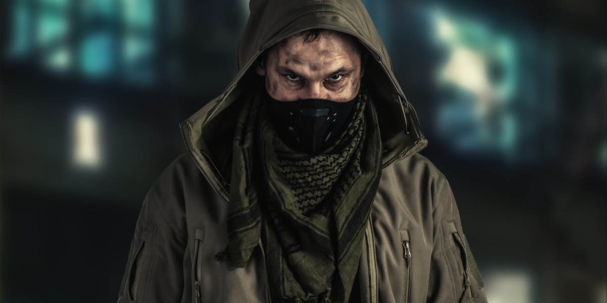 man wearing a black mask and green hood