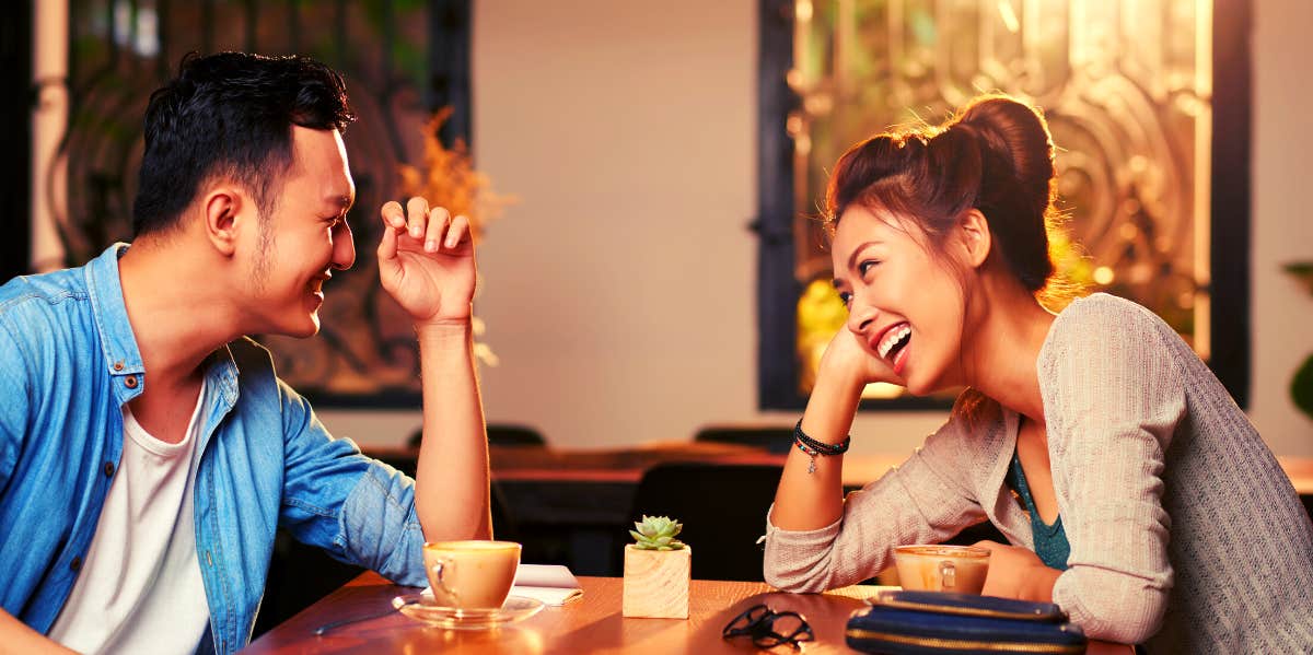 couple talking and laughing over coffee date