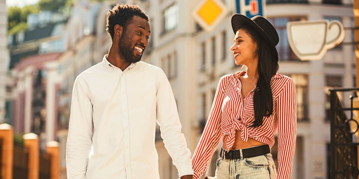 Happy African-American couple walking hand in hand