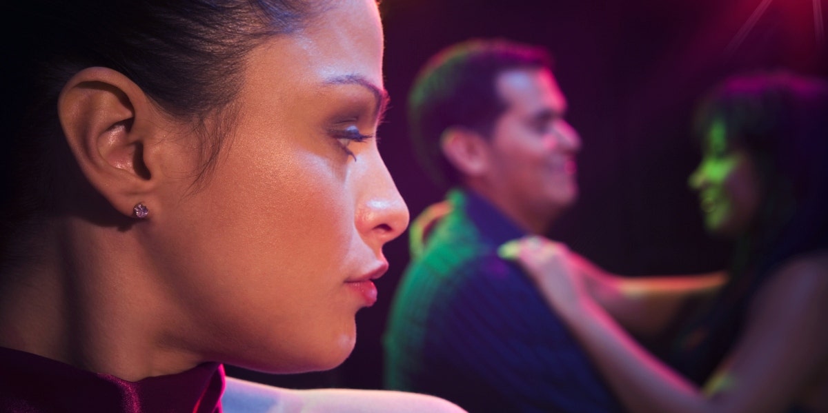 woman watching couple dancing