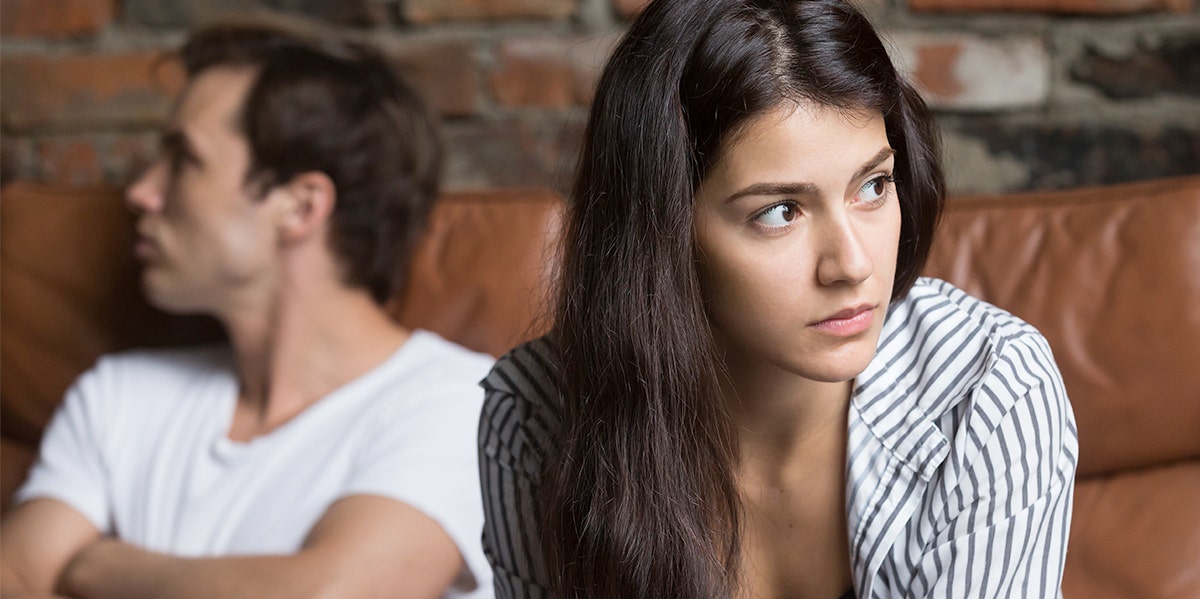 woman looking away from man who looks annoyed