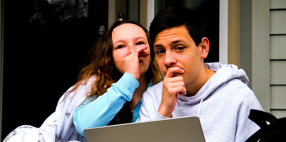 Phrases That Drive Guys Crazy (And Not In The Good Way) woman whispering to man