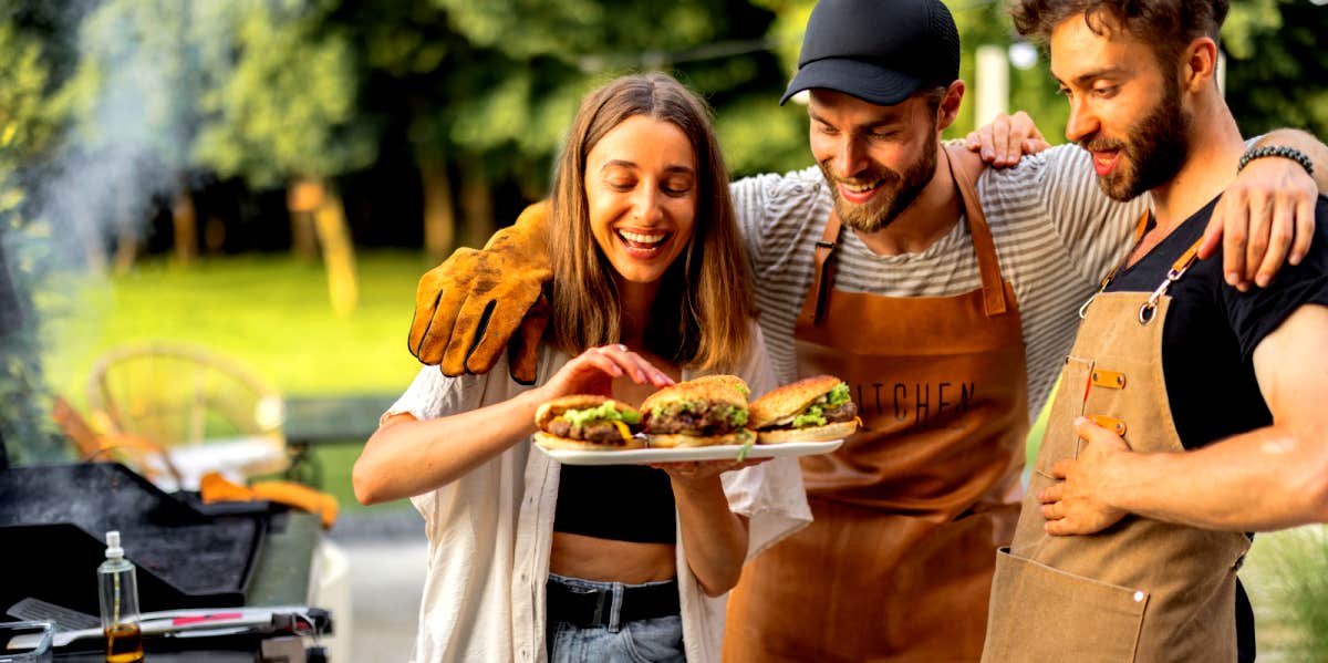 woman at a bbq with two men