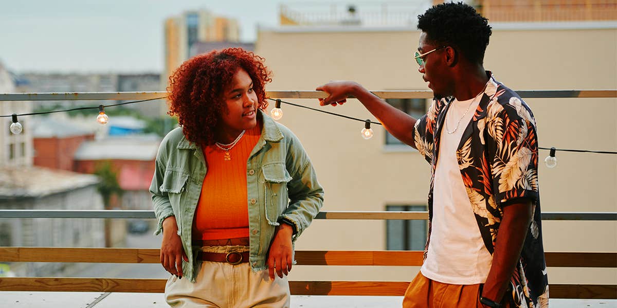 man flirting with woman on rooftop