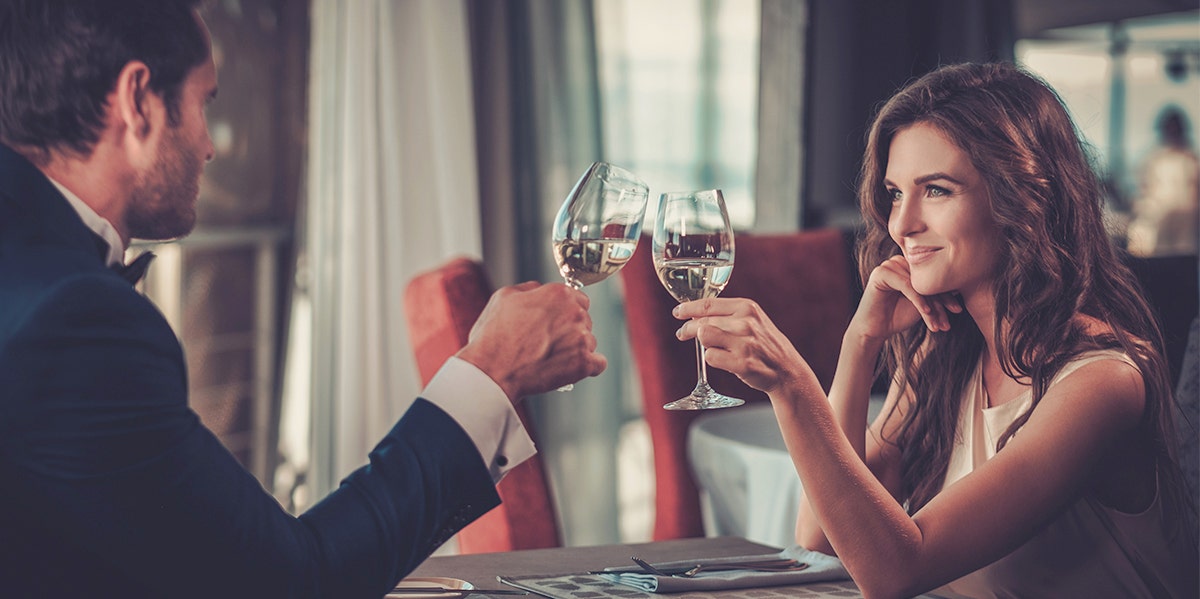 husband and wife clinking glasses together in celebration