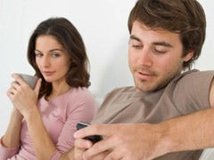 man texting on phone ignoring woman