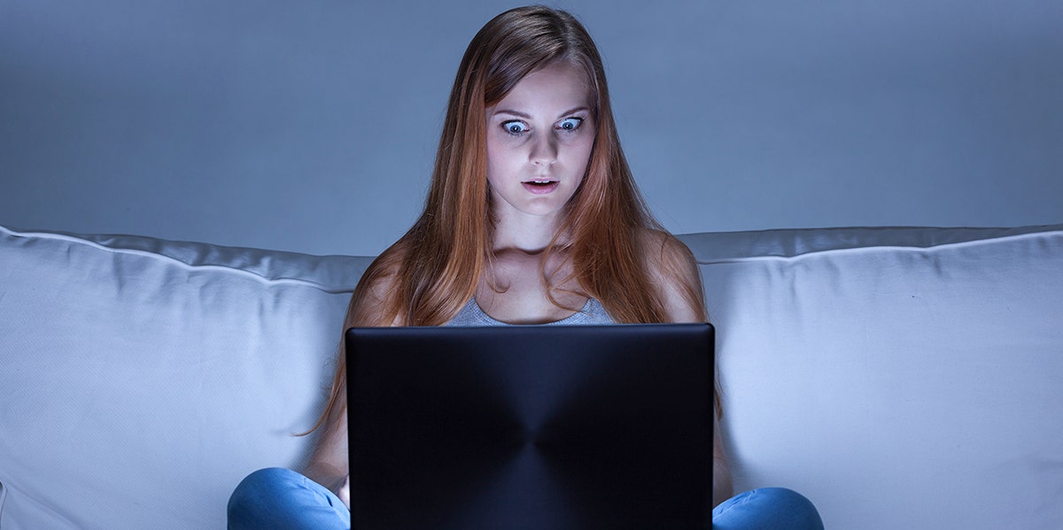 woman looking horrified at computer screen