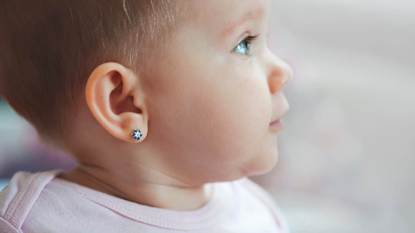 baby side profile with pierced ears