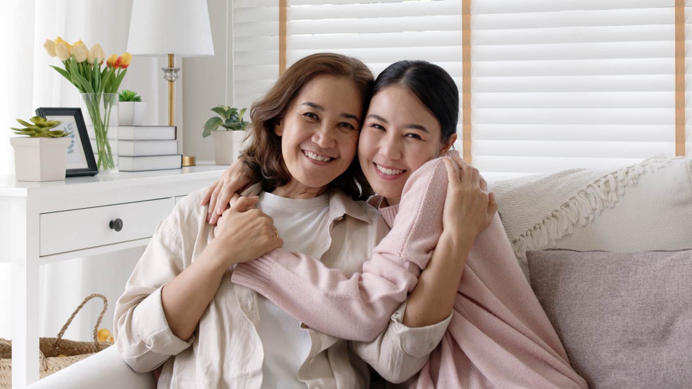 mom and daughter embracing on couch